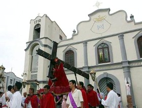 Picture: Reverent: The statue of Christ carrying the cross being taken out of the church to begin the procession