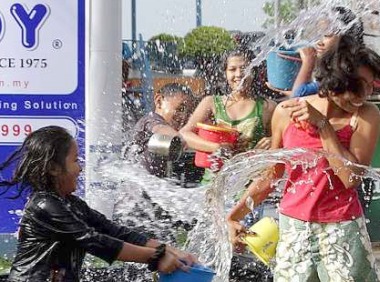 Image: Residents having fun splashing water on each other